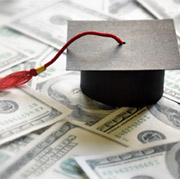 graduation cap on top of money